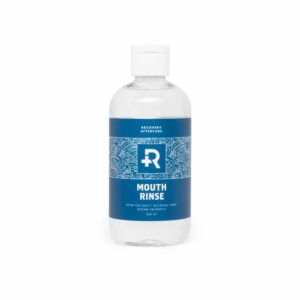 Recovery piercing mouth wash rinse in a clear plastic bottle